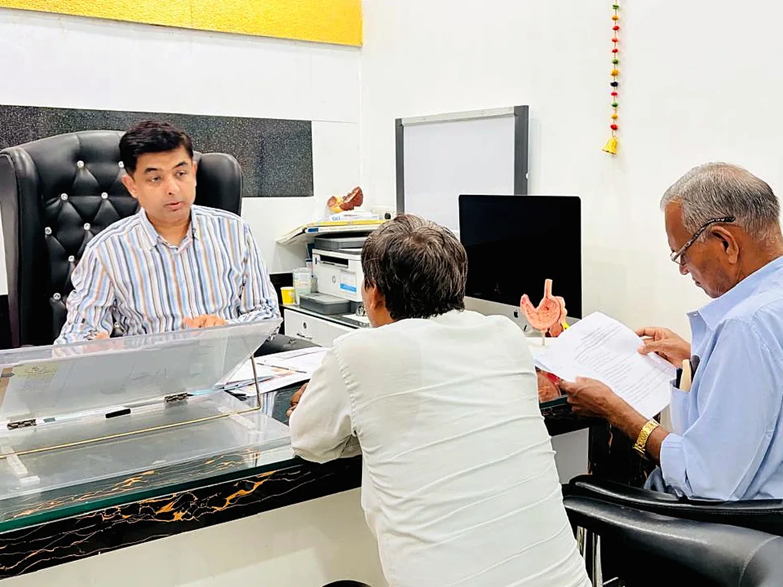 Dr. Himanshu Yadav discussing medical reports with patients